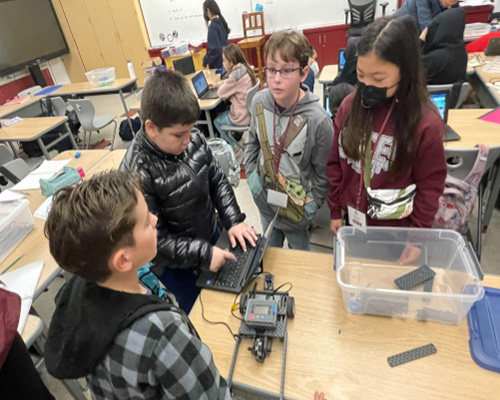 Elementary students working with VEX IQ kits in Mrs. Pak’s STEAM class.